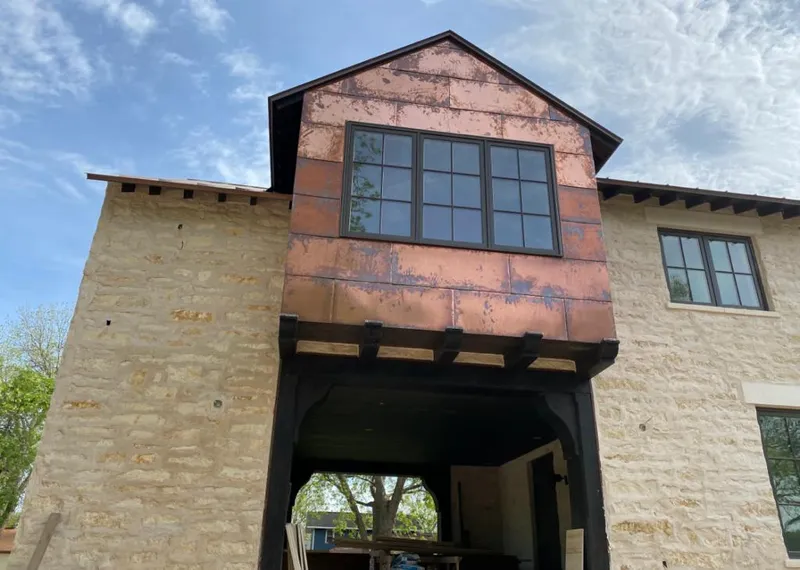 Copper metal panel facade on a stone building for Skylight Installation in North Port